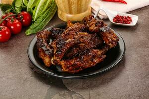 Grilled pork ribs in barbecue sauce photo