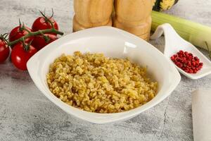 Boiled bulgur wheat in the bowl photo