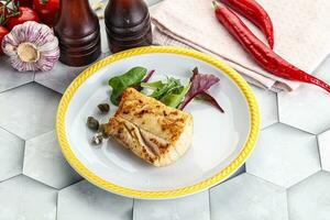 Roasted cod fish steak with salad photo