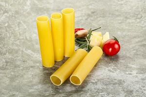 Raw uncooked Italian pasta Cannelloni photo