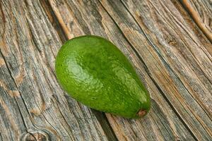 Ripe green avocado over background photo