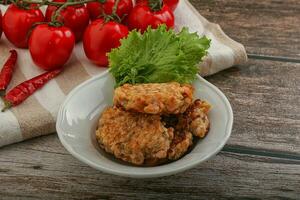 Fried salmonn cutlet in the bowl photo