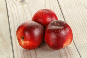 Ripe sweet juicy nectarines heap photo