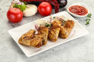 Grilled chicken wings with sauce photo