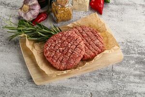 Raw burger cutlet for grill photo