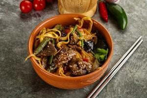 Asian wok with noodle, vegetables and beef photo