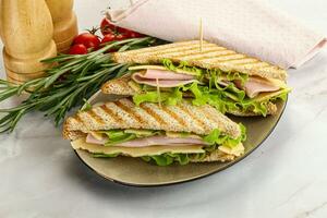 Homemade club sandwich with ham and cheese photo