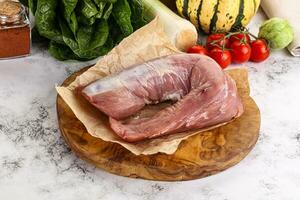 Uncooked raw pork tenderloin with spices photo