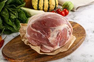 Uncooked raw pork knuckle with spices photo