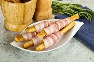 Crispy grissini italian bread with bacon photo