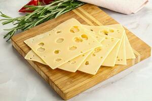 Sliced maasdam cheese with holes photo