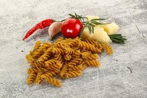 Raw whole grain pasta fusilli photo