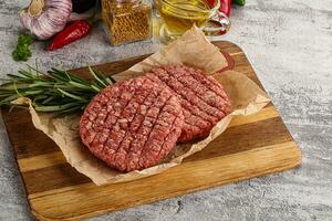 Raw burger cutlet for grill photo