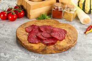 Smoked beef meat - Pastrami slices photo