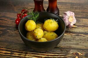 Boiled potato with oil and dill photo