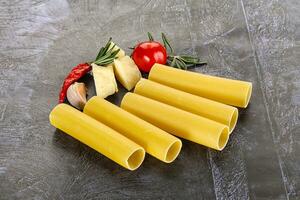 Raw uncooked Italian pasta Cannelloni photo