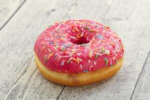 Sweet glazed struwberry donut with icing photo