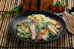 Caesar salad with chicken and romano photo