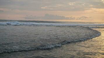 waves crashing on the white sand beach photo