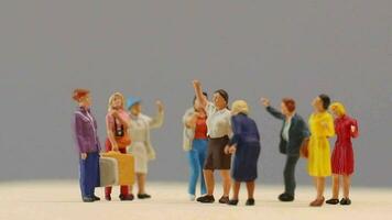 Miniature people , A group of women stand together On a gray backdrop, International Women's Day concept video