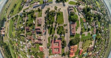 tiny planet in sky with clouds overlooking old town, urban development. Transformation of spherical 360 panorama in abstract aerial view. video