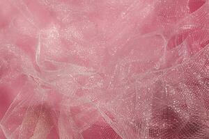 Pink tulle fabric texture top view. Coral background. Fashion color trends feminine tutu skirt flat lay for female blog. photo