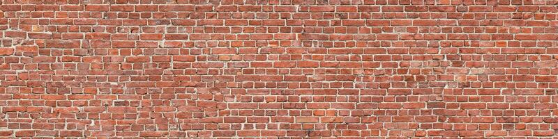 Panorama of an old red brick wall as a background or texture photo