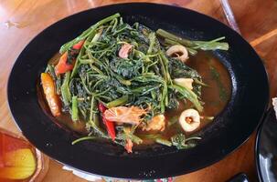 Tumis Kangkung or Stir fried Water Spinach is one of Indonesian daily menu photo