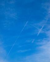 Condensation trail of passenger aircraft in form of a lattice in the sky. photo