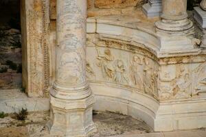 Bas-reliefs of antique scenes on the gables of the amphitheater in Hierapolis, Turkey. photo