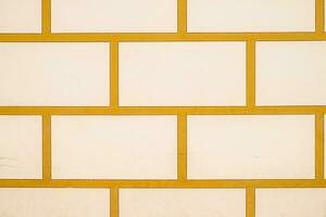 Background texture white bricks and yellow cement. Masonry of stone. photo