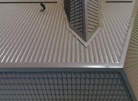 A view from above on the roof of the house. The roof of corrugated sheet. Roofing of metal profile wavy shape photo