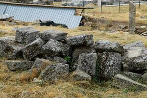 Fragments of ancient buildings, ruins of the ancient city of Hierapolis. Stone blocks with traces of stone machining. photo