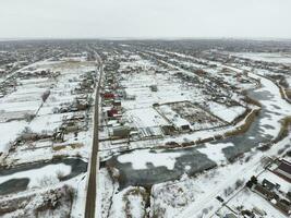 Winter view from the bird's eye view of the village. The streets are covered with snow photo