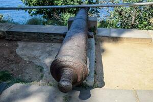 Old cast-iron cannon on the waterfront photo