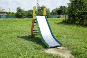 Children's playground. Swing, carousel and slide photo