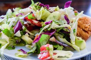 assorted salad with cucumbers and purple leaflets photo