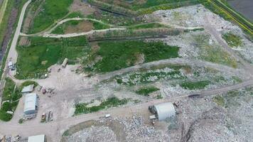 garbage dump with heaps of garbage and treatment facilities. Landfill of garbage outside the village photo