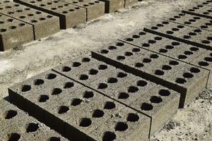 Cinder blocks lie on the ground and dried. on cinder block production plant. photo