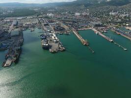 Industrial seaport, top view. Port cranes and cargo ships and barges. photo