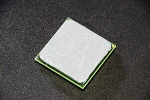 The processor of the computer with the thermal paste applied on it. Details of the computer's system unit. photo