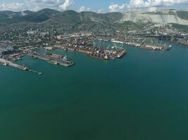 Industrial seaport, top view. Port cranes and cargo ships and barges. photo