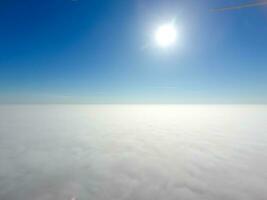 In the skies above the fog. Sunrise over the fog. Clouds near the ground photo