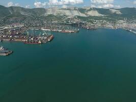 Industrial seaport, top view. Port cranes and cargo ships and barges. photo