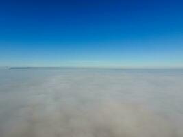 In the skies above the fog. Sunrise over the fog. Clouds near the ground photo