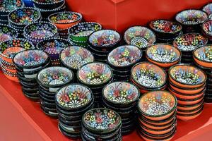 Painted beautiful dishes on the counter. photo