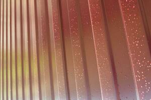 metal profile. Diagonal pattern of metal profile. Fences from the galvanized iron painted by a polymeric covering. photo