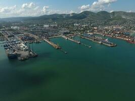 Industrial seaport, top view. Port cranes and cargo ships and barges. photo