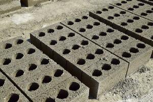 Cinder blocks lie on the ground and dried. on cinder block production plant. photo