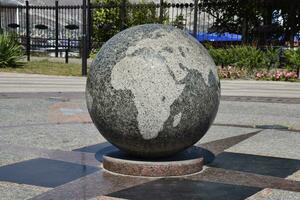 Granite bowl engraved maps of the world. The symbol of peace and unity photo